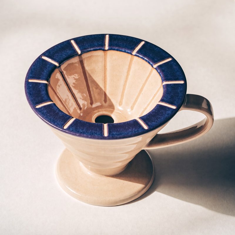 Concept sample: the dripper from above at an angle, showing the indigo rim, ribbed inner cone and side loop