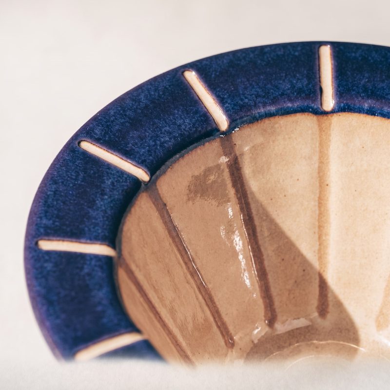 Concept sample: close-up of the indigo rim with recessed oat tick marks and the glossy inner cone
